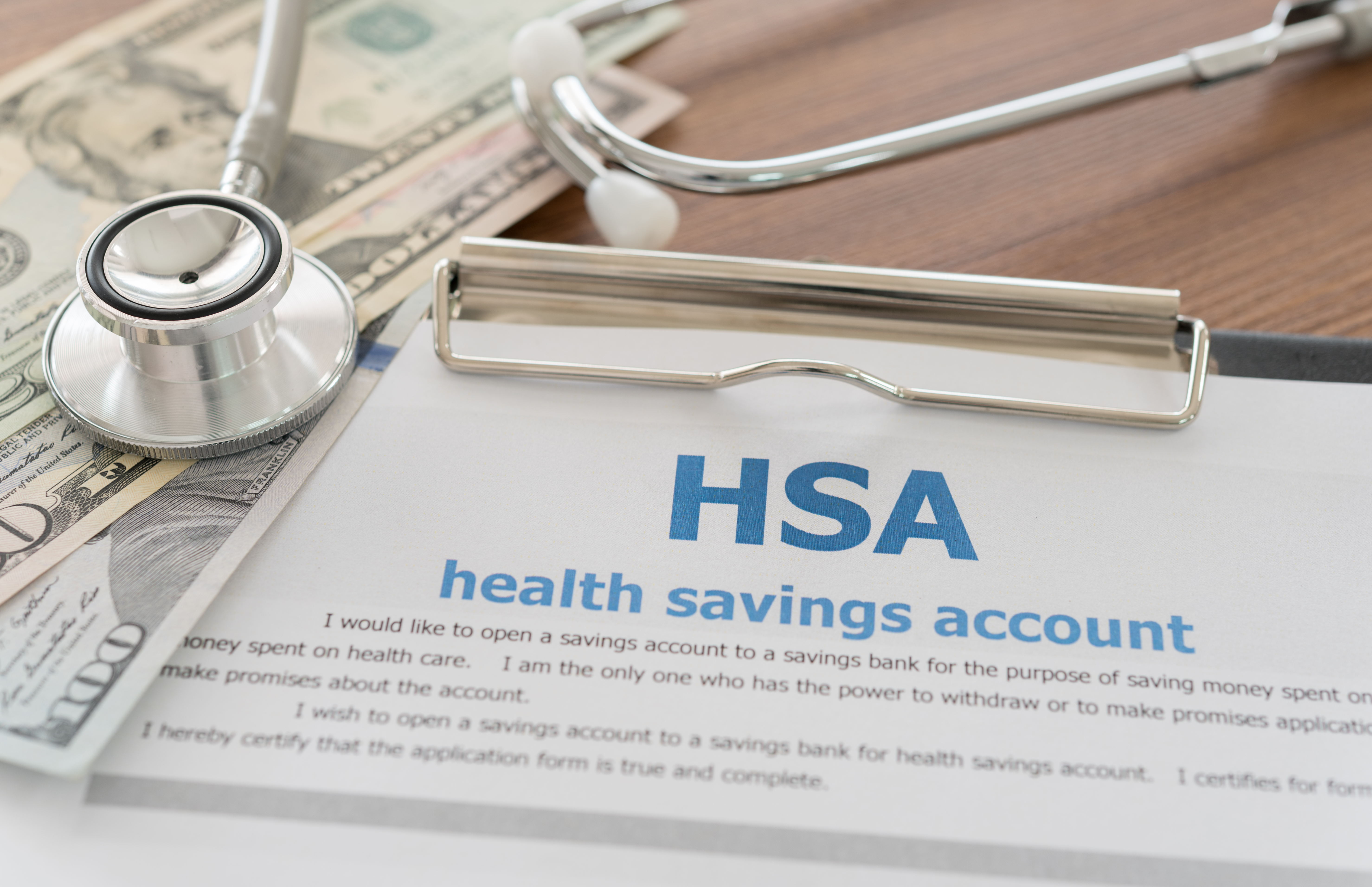 HSA paperwork with money on top.