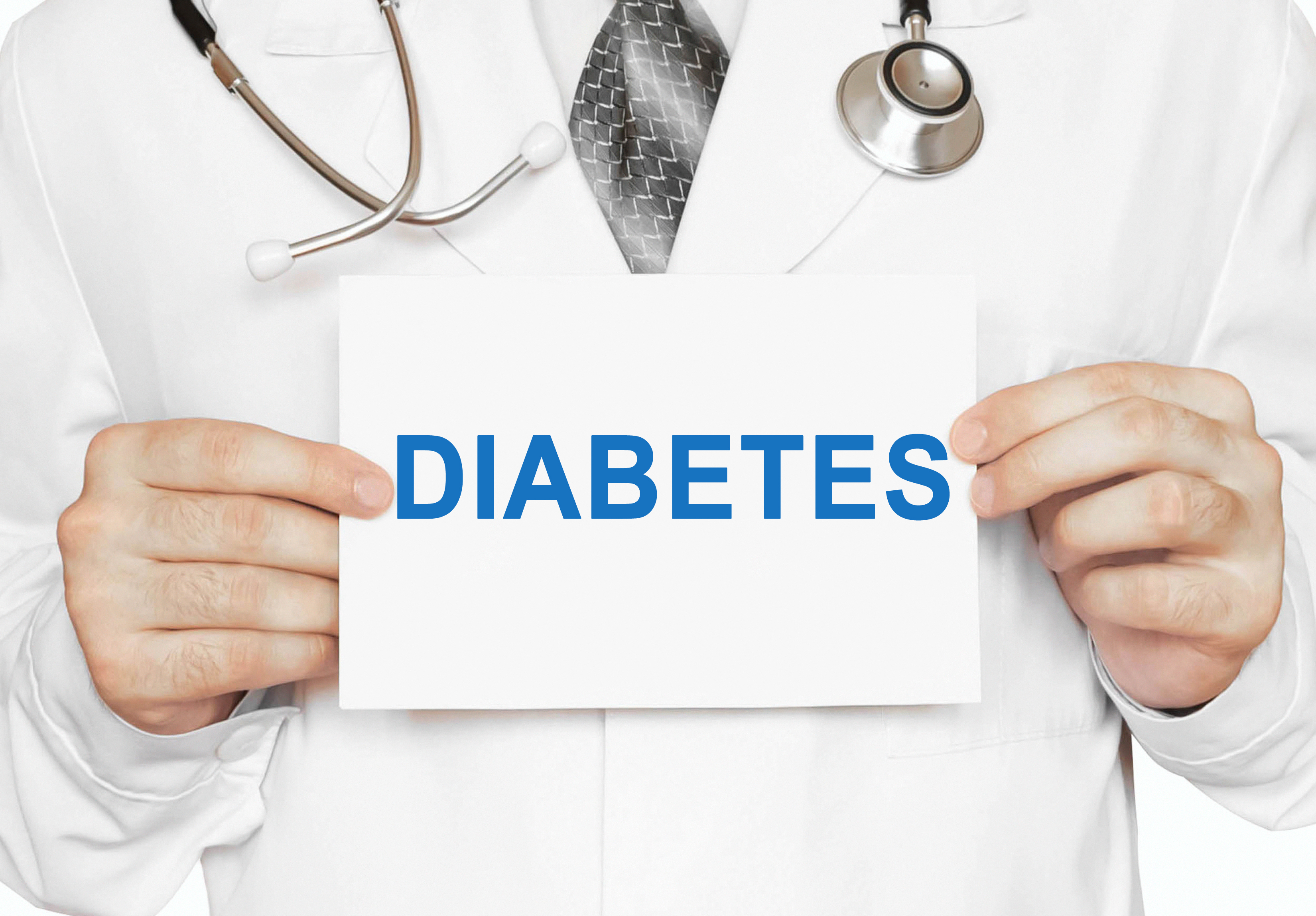 Physician holding up a paper reading Diabetes.