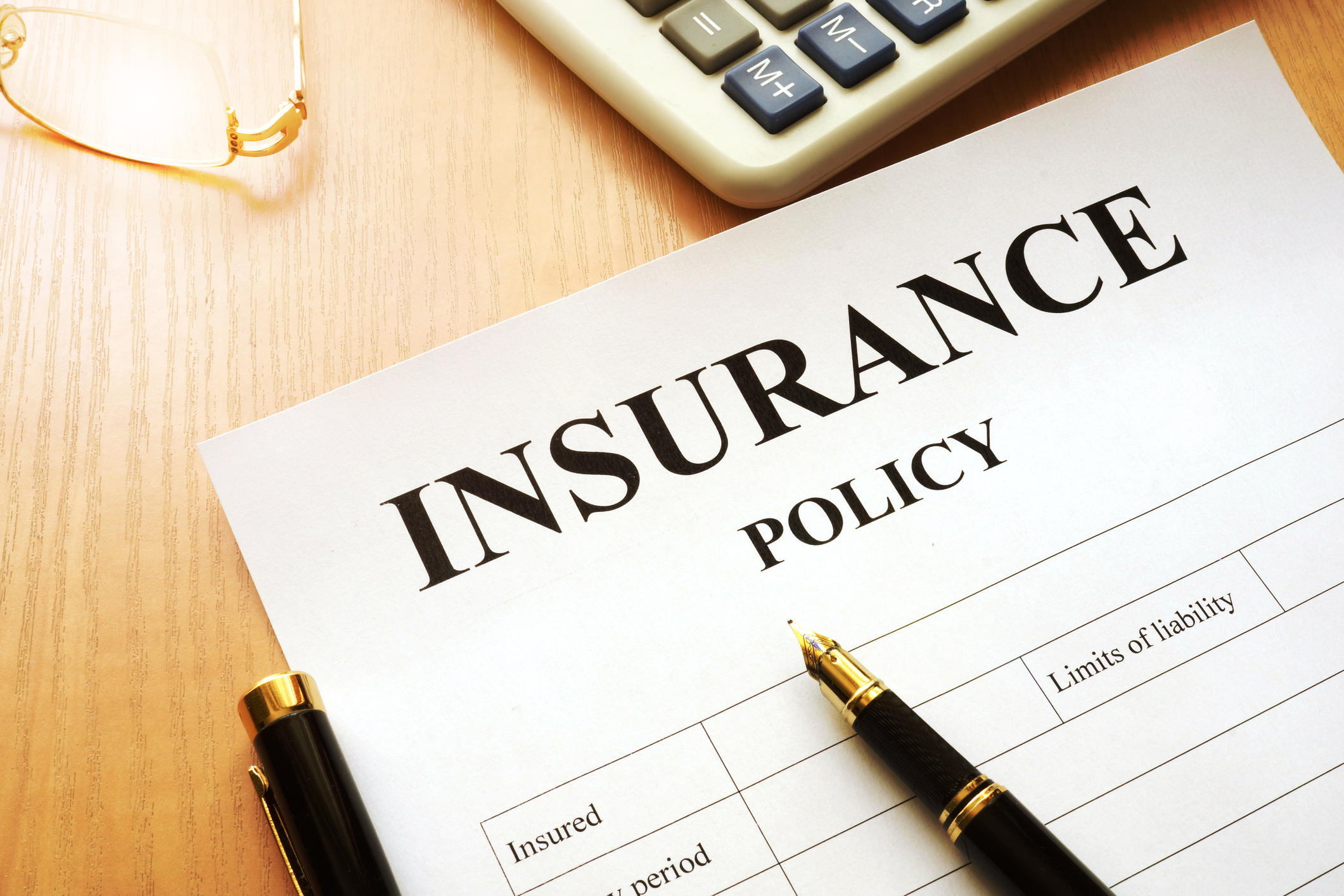 Insurance policy document Insurance policy document with a pen lying on top.