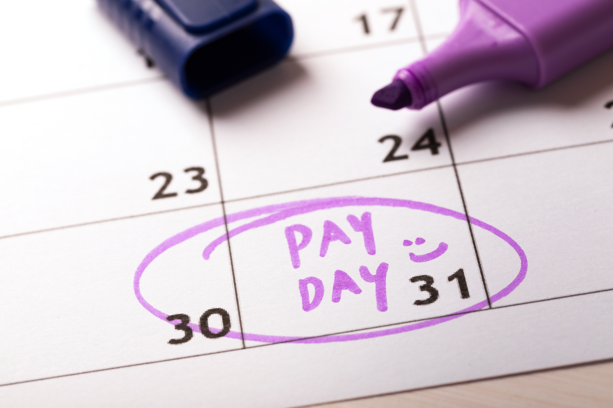 Pay day marked on a calendar in purple highlighter.