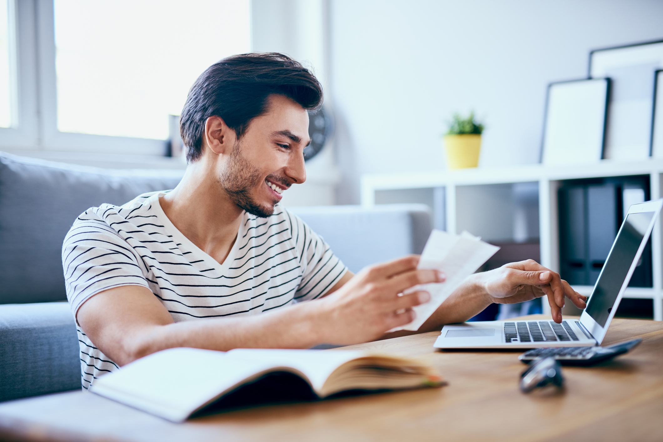 Man paying bills online from laptop