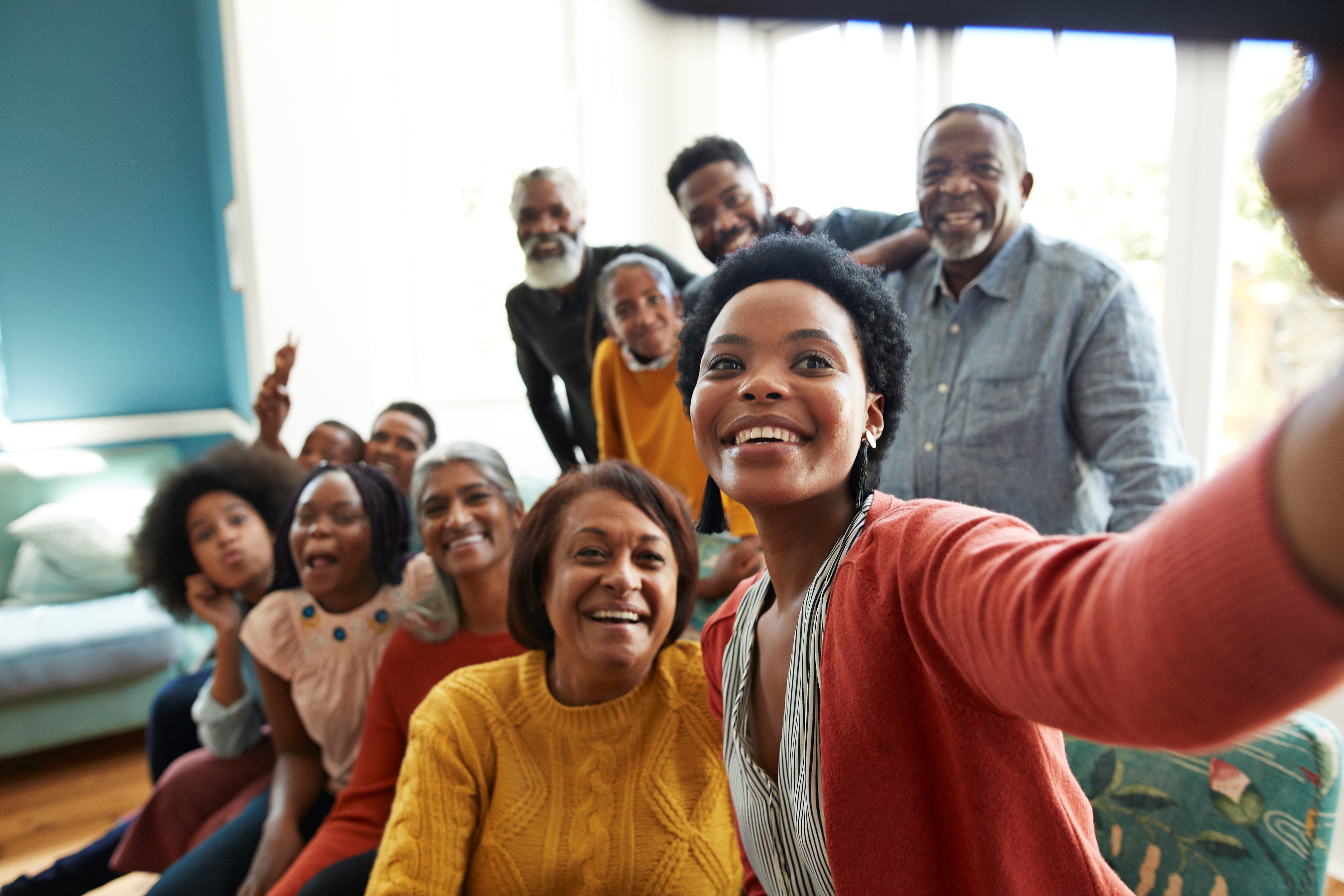 A group of people smiling for a selfie. A group of people smiling for a selfie.
