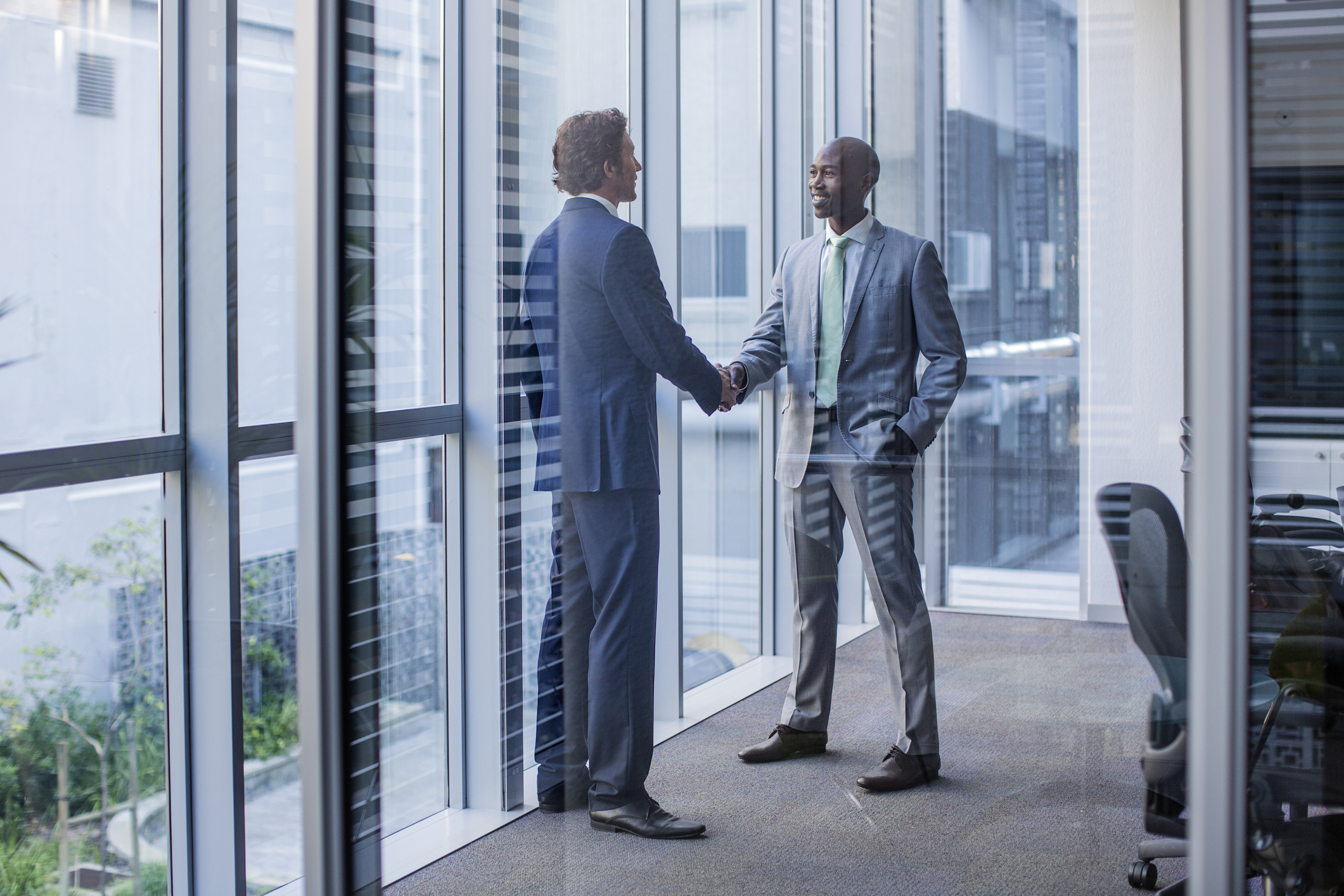 People shaking hands in an office setting.