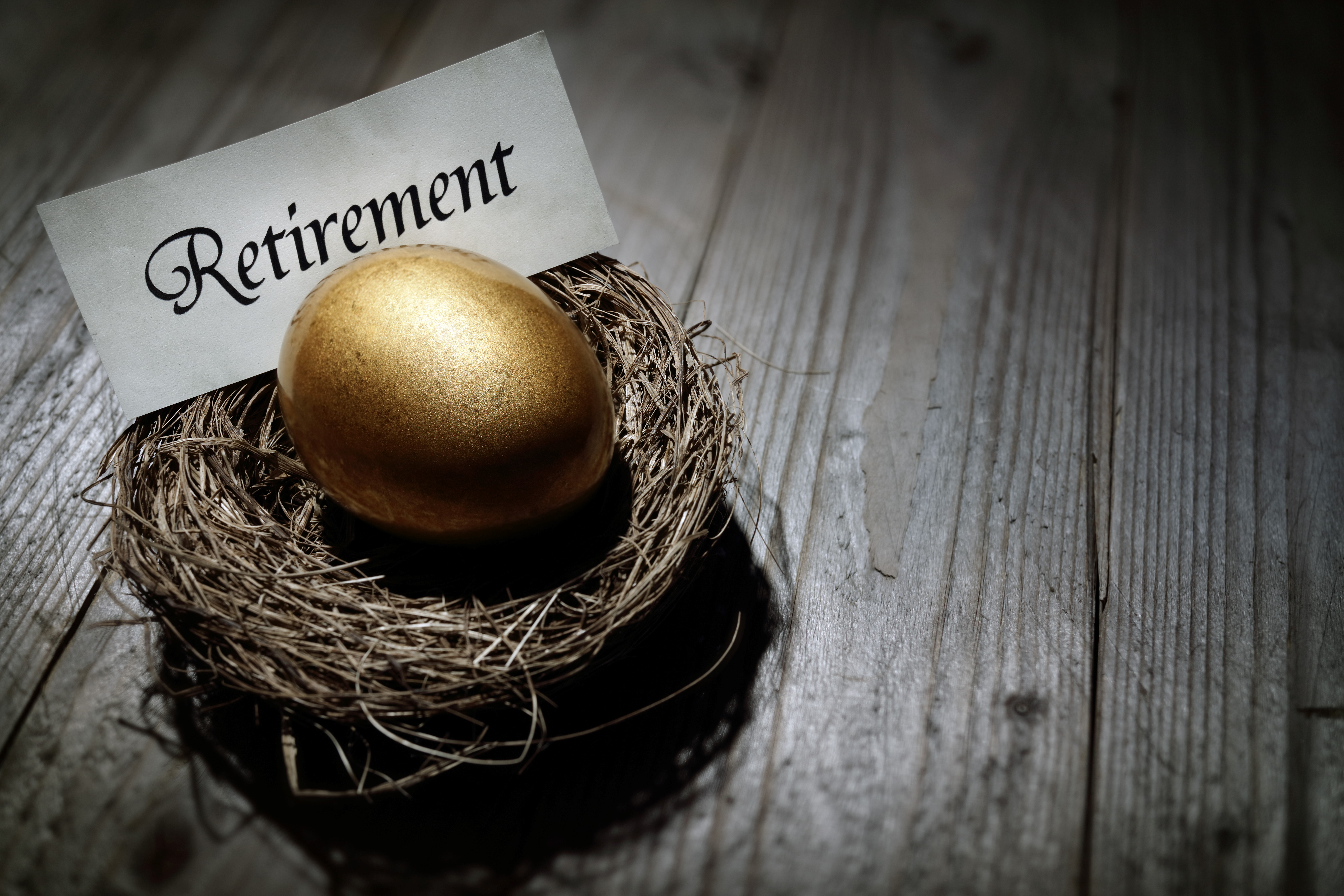 A golden egg in a nest with a sign reading Retirement A golden egg in a nest with a sign reading Retirement.