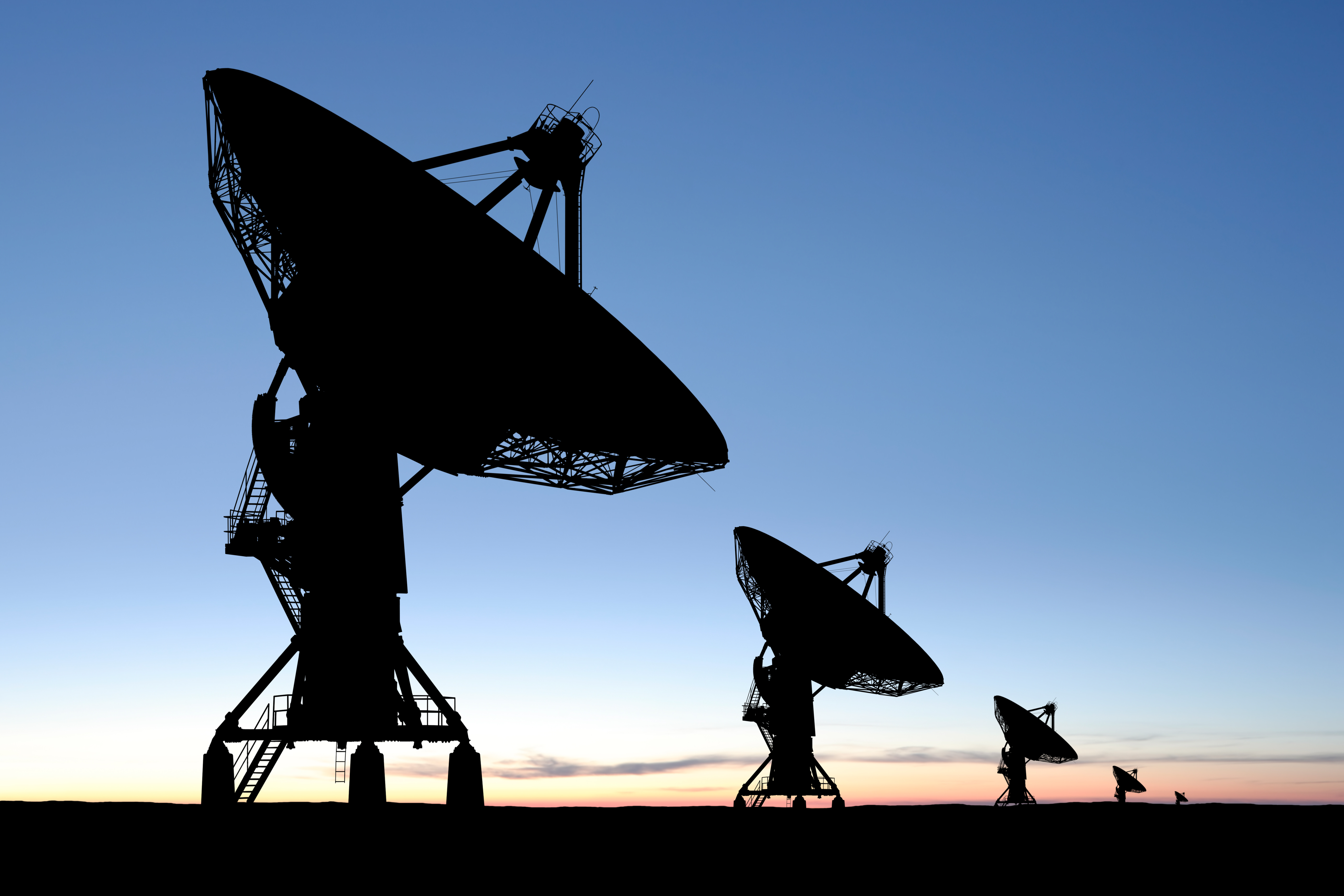 Satellite dishes pointed at the sky at dawn. Satellite dishes pointed at the sky at dawn.