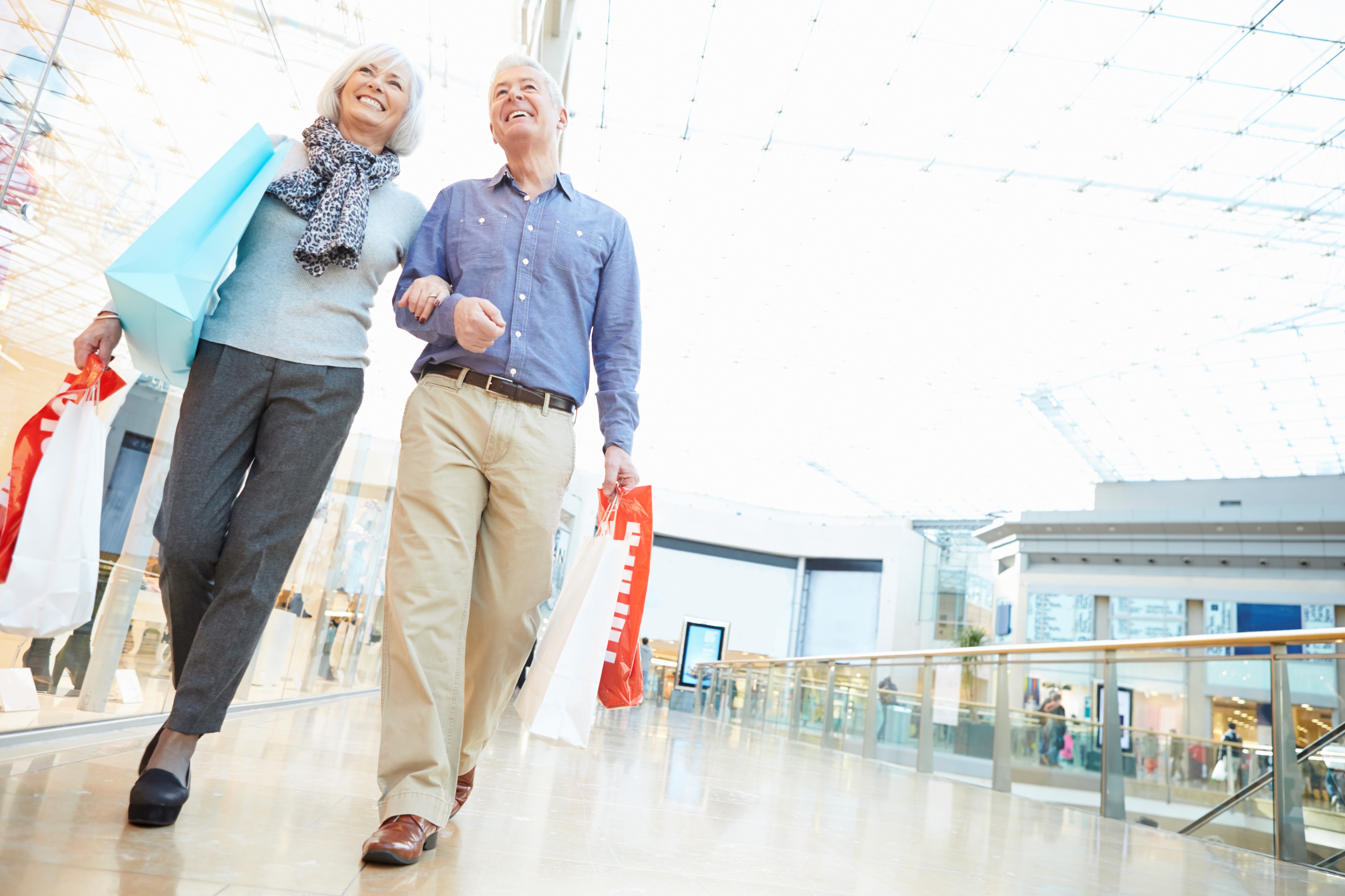 Senior couple shopping together in a mall.