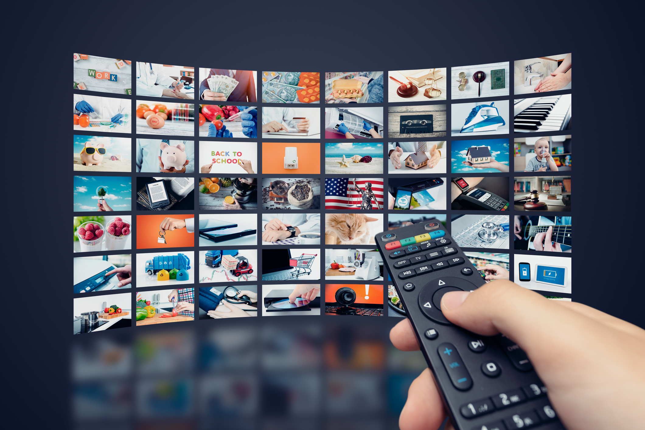 Person holding remote and streaming shows