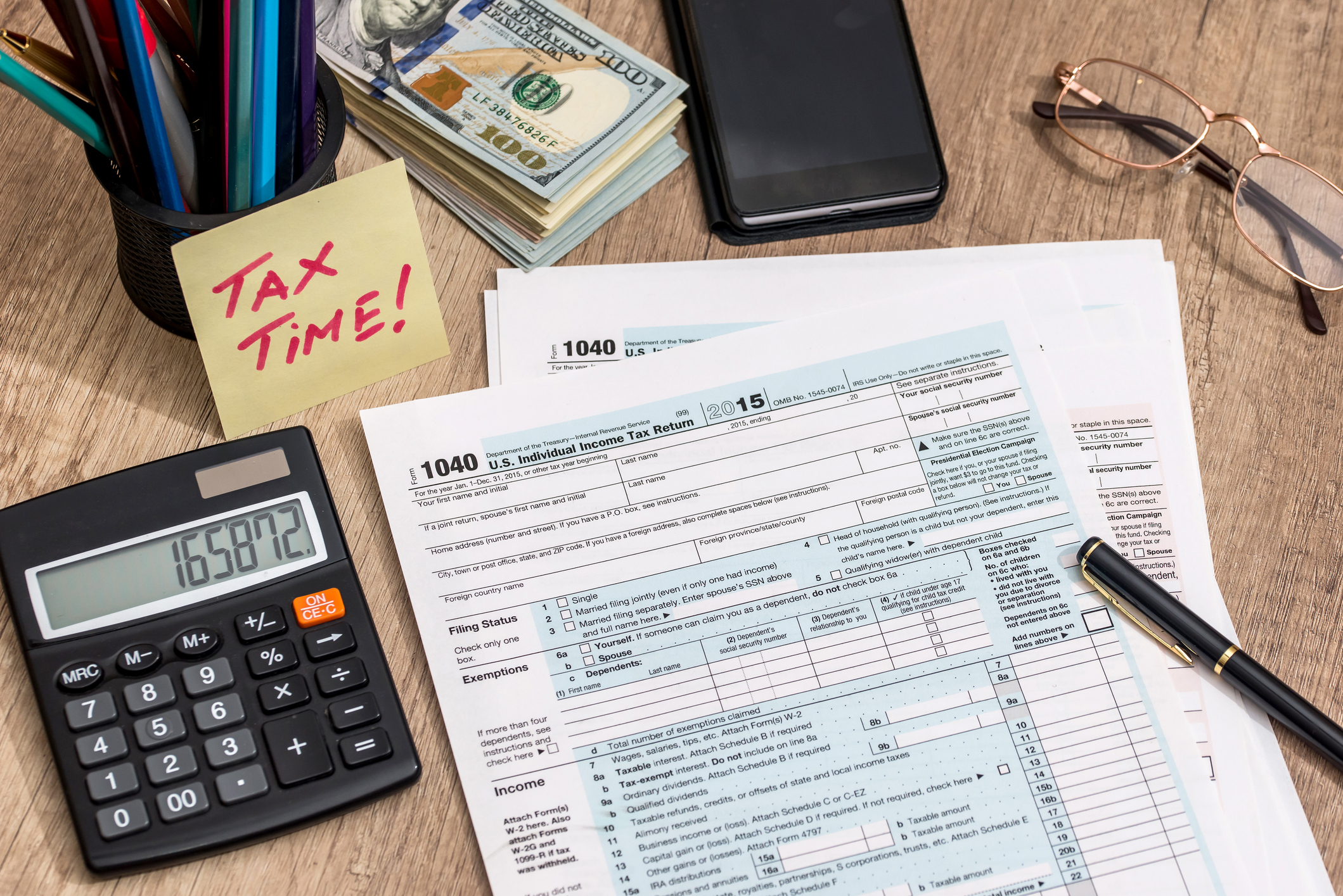 Tax documents on a desk with a calculator