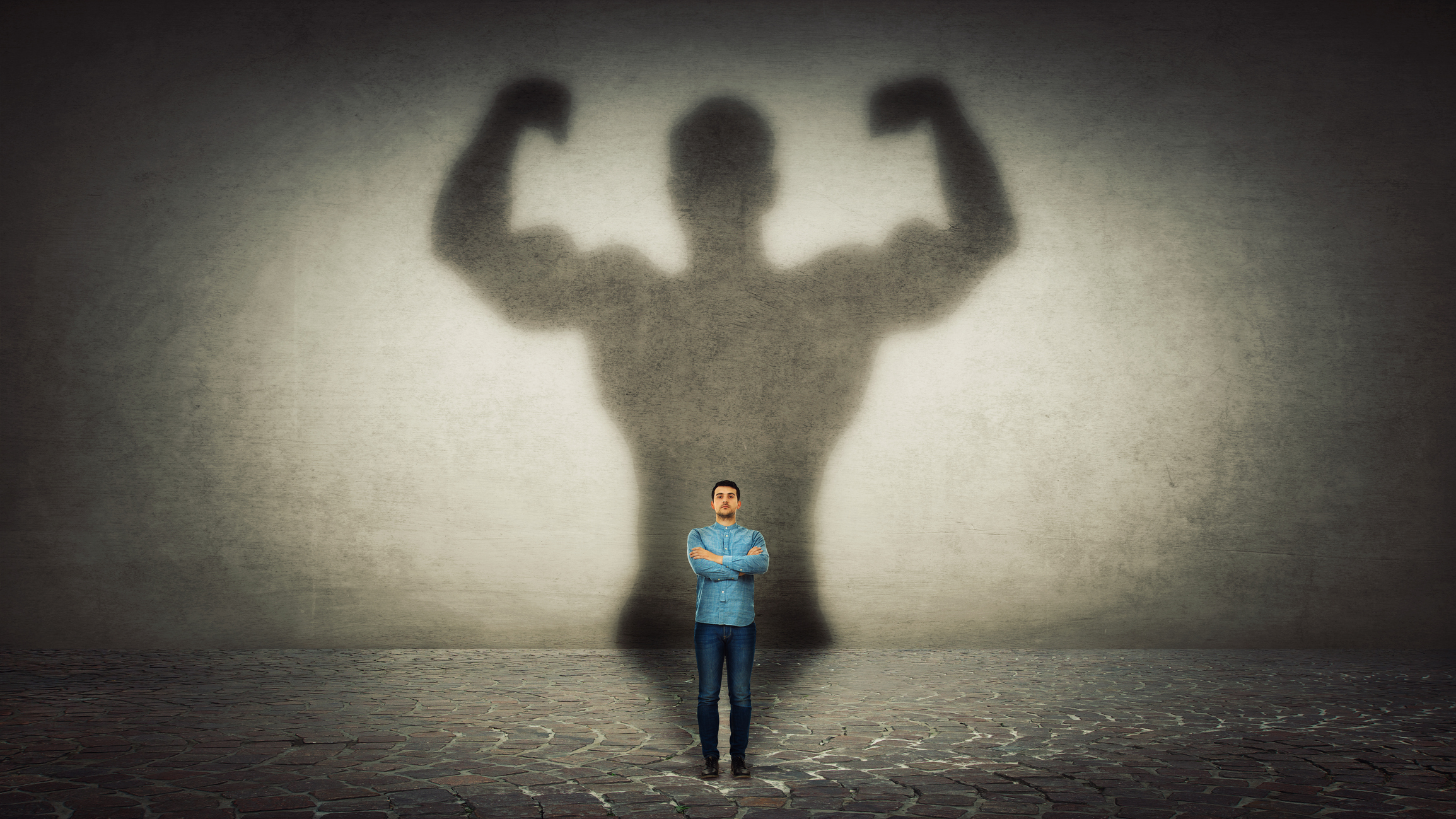 Tiny man with his big strong shadow behind him.jpg Tiny person casting a big strong shadow.