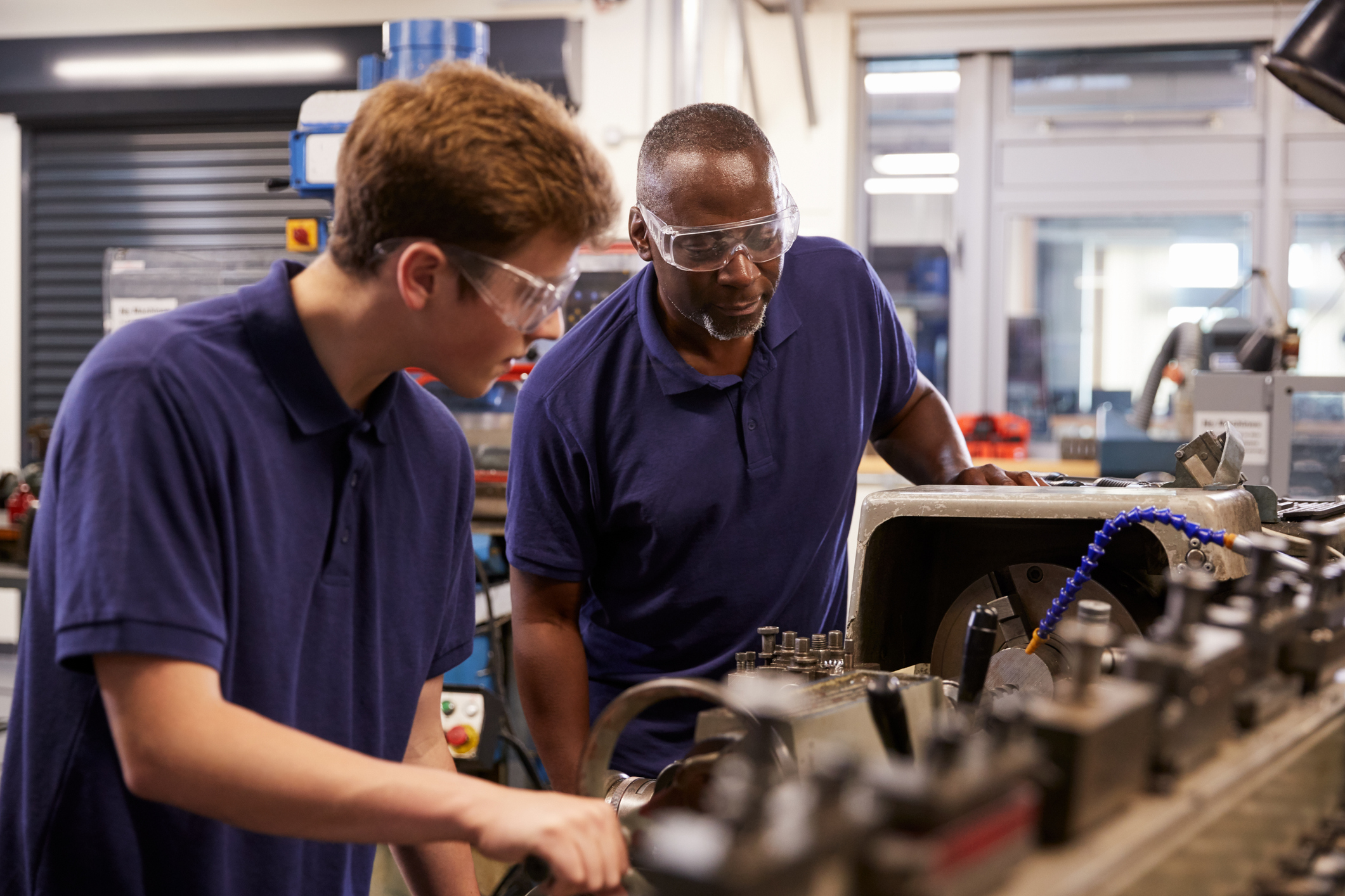 Two men working in a factory. Two men working in a factory.