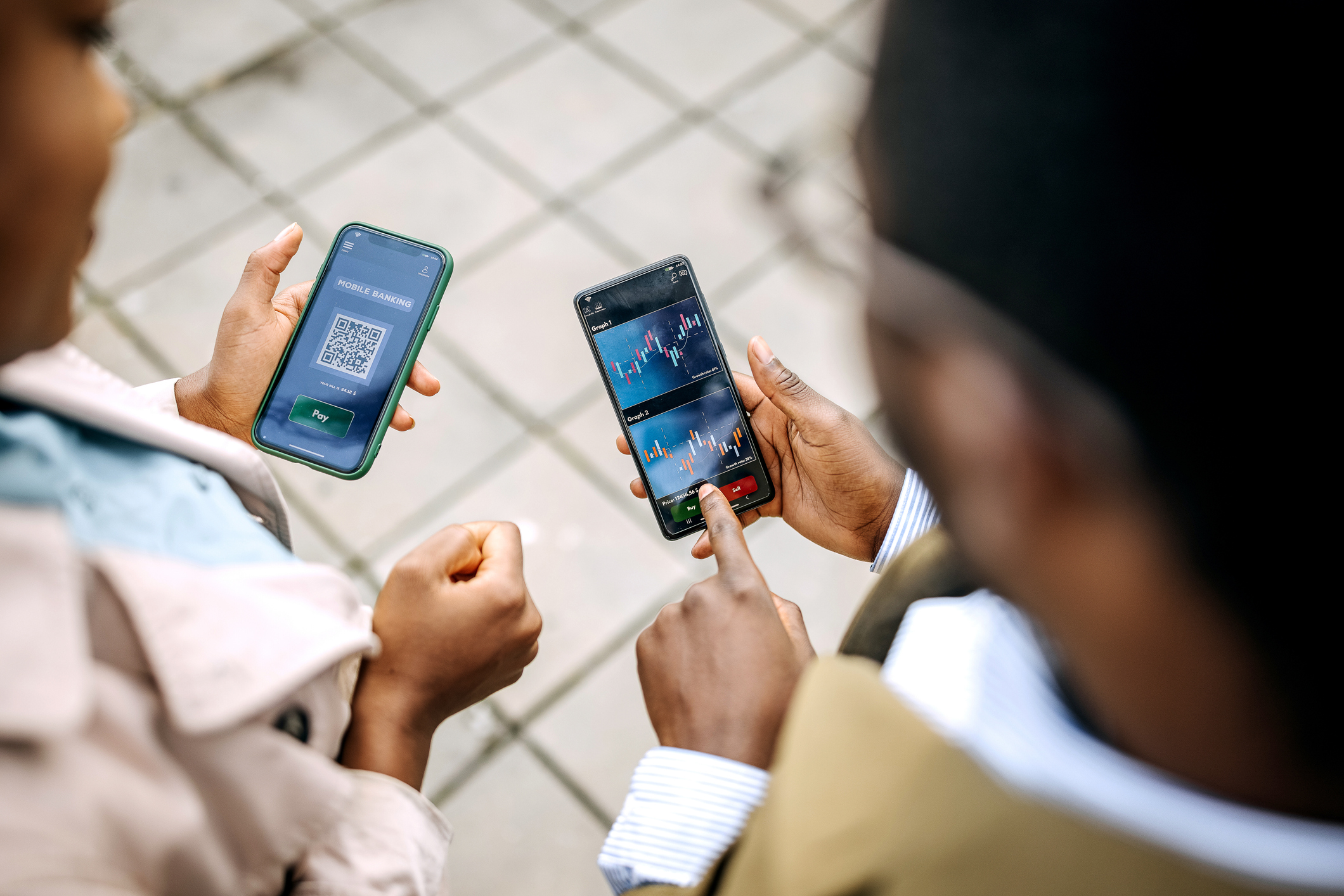Young colleagues checking their crypto investment app Young colleagues checking their crypto investment app