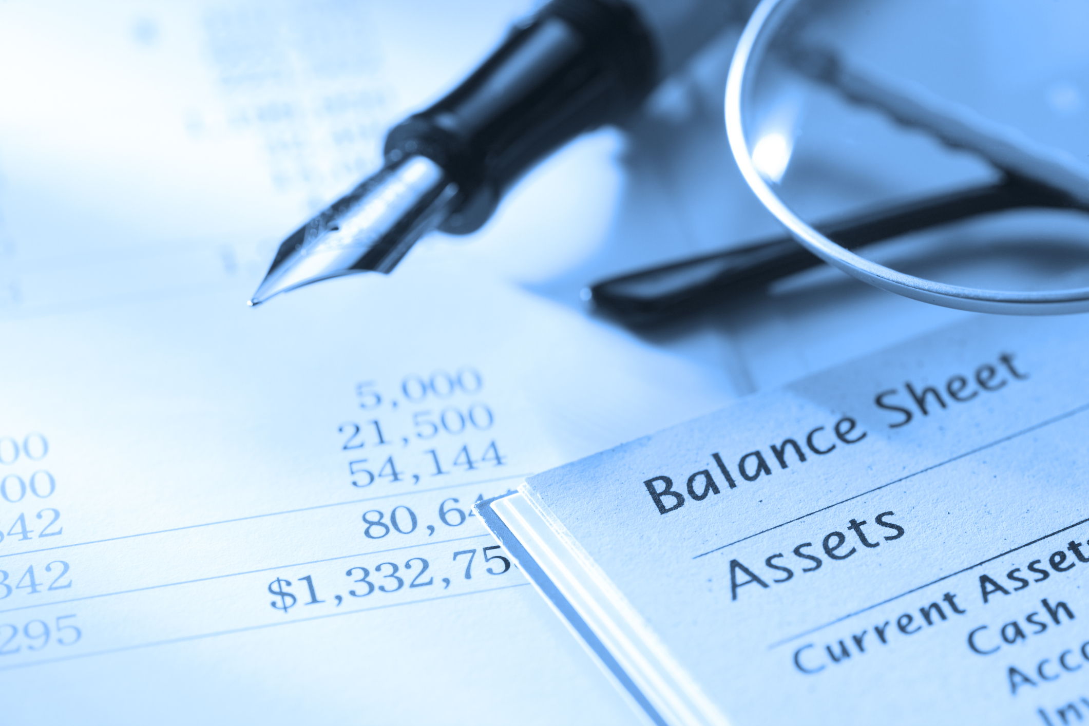 balance sheet with a fountain pen Balance sheet with a fountain pen and glasses lying on top.