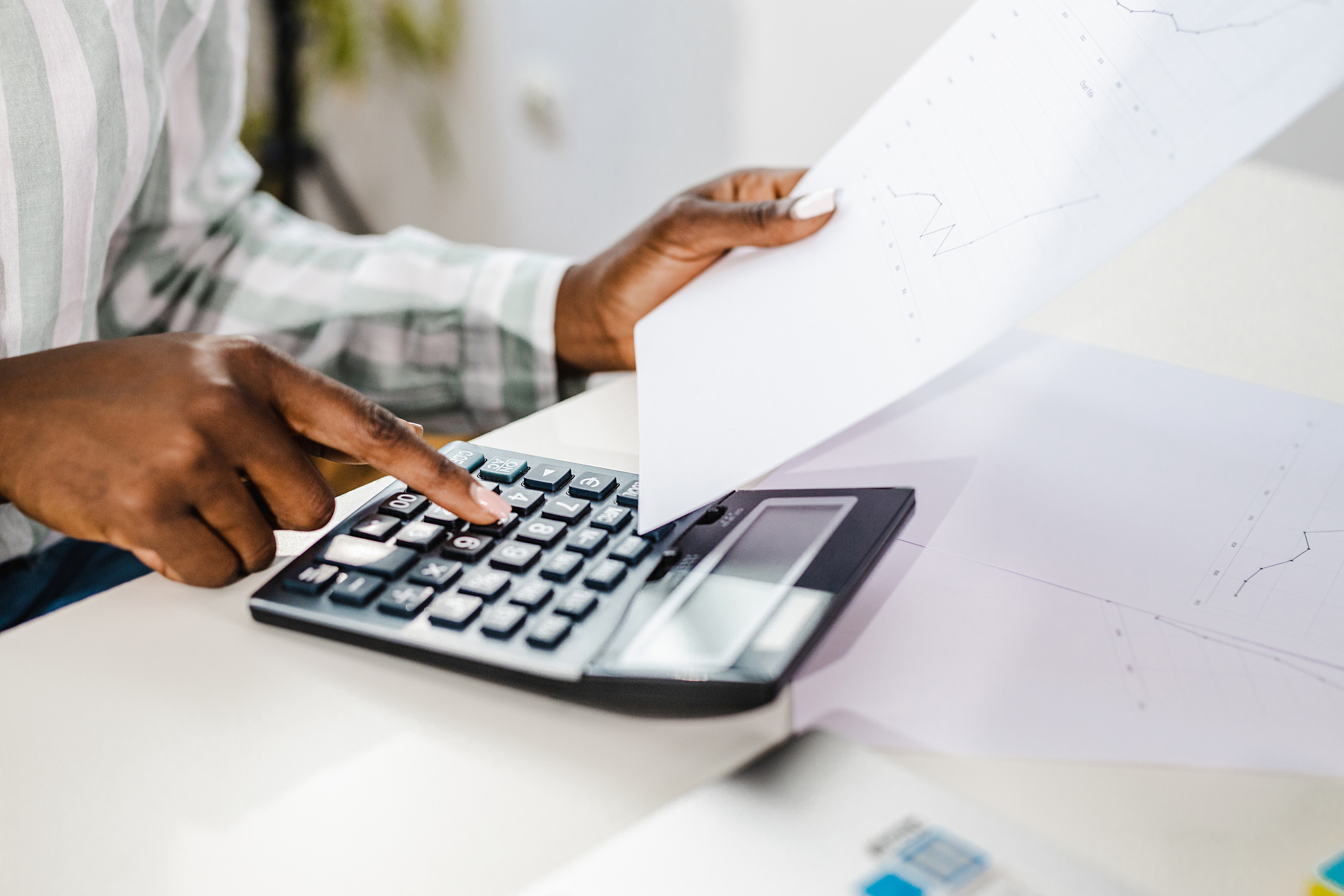 calculator and holding a paper calculator and holding a paper