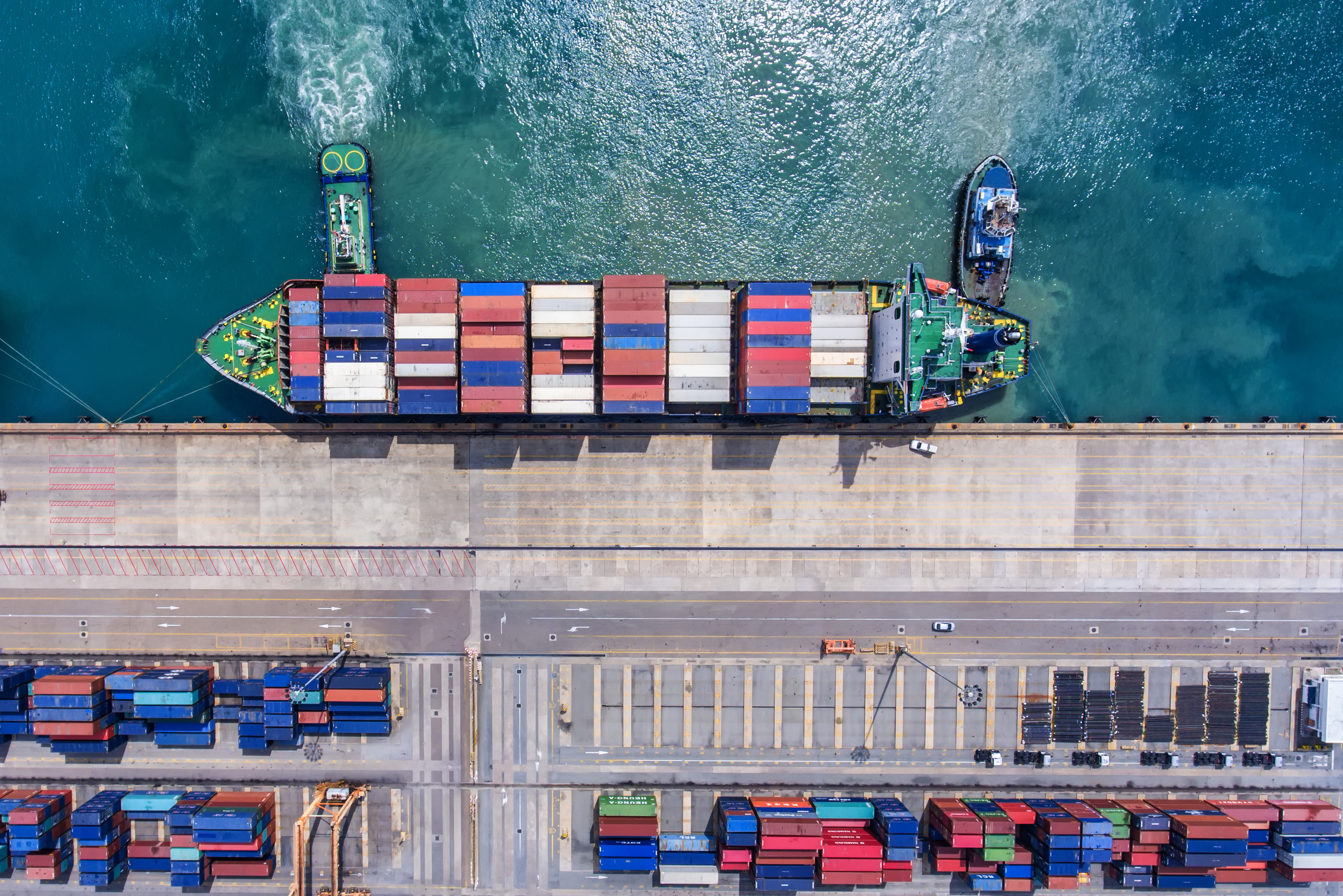 container ship tied at dock covered with shipping containers -- import export global trade A container ship tied at a dock covered with shipping containers.