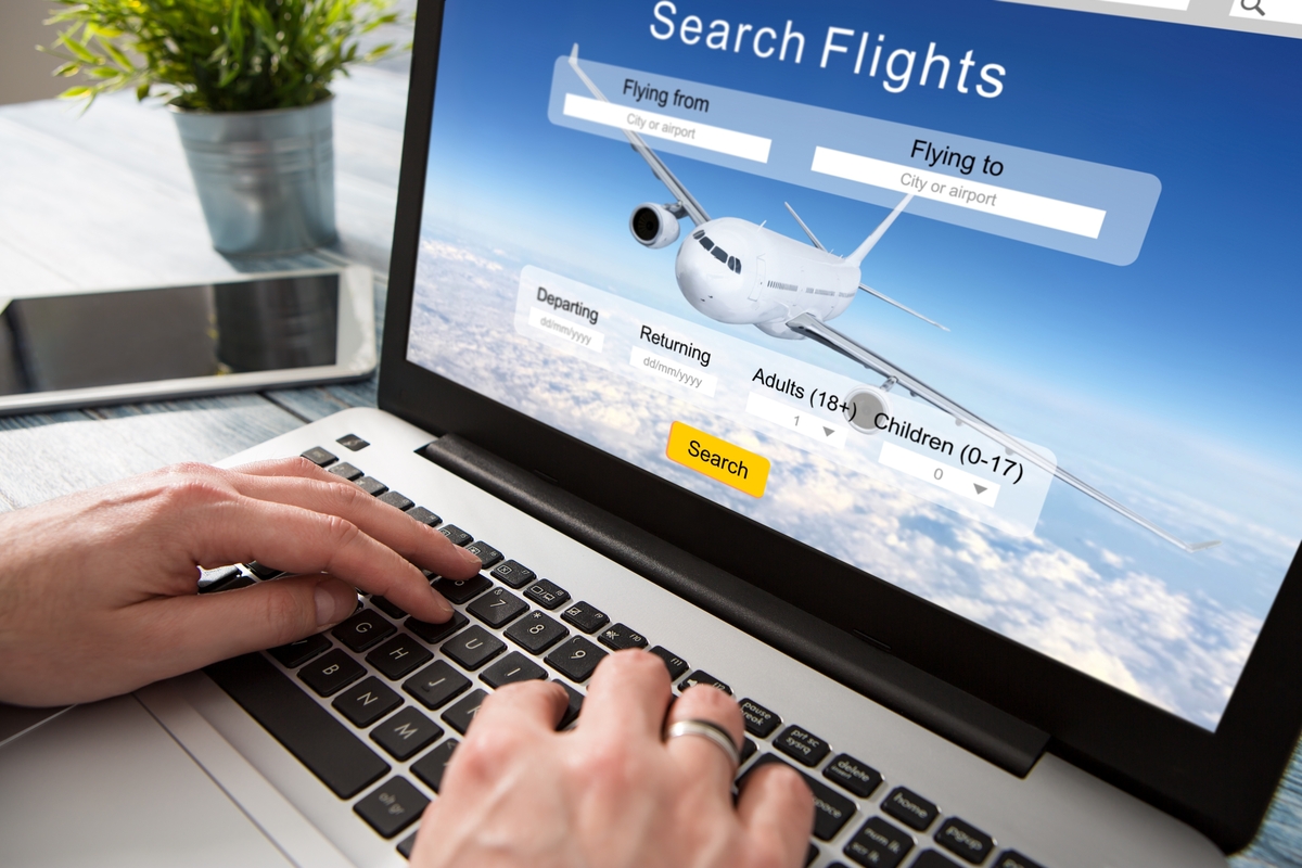 flights travel vacation expedia google flights-1200x800-5b2df79 Person searching for flights on an online travel site.