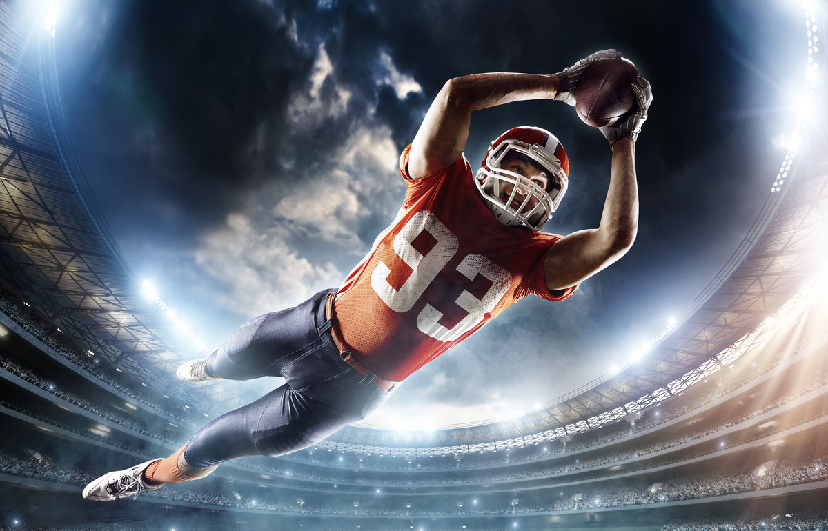 football sports entertainment ESPN touchdown-1201x770-e4ab506 Football player soaring through the air to land a touchdown.