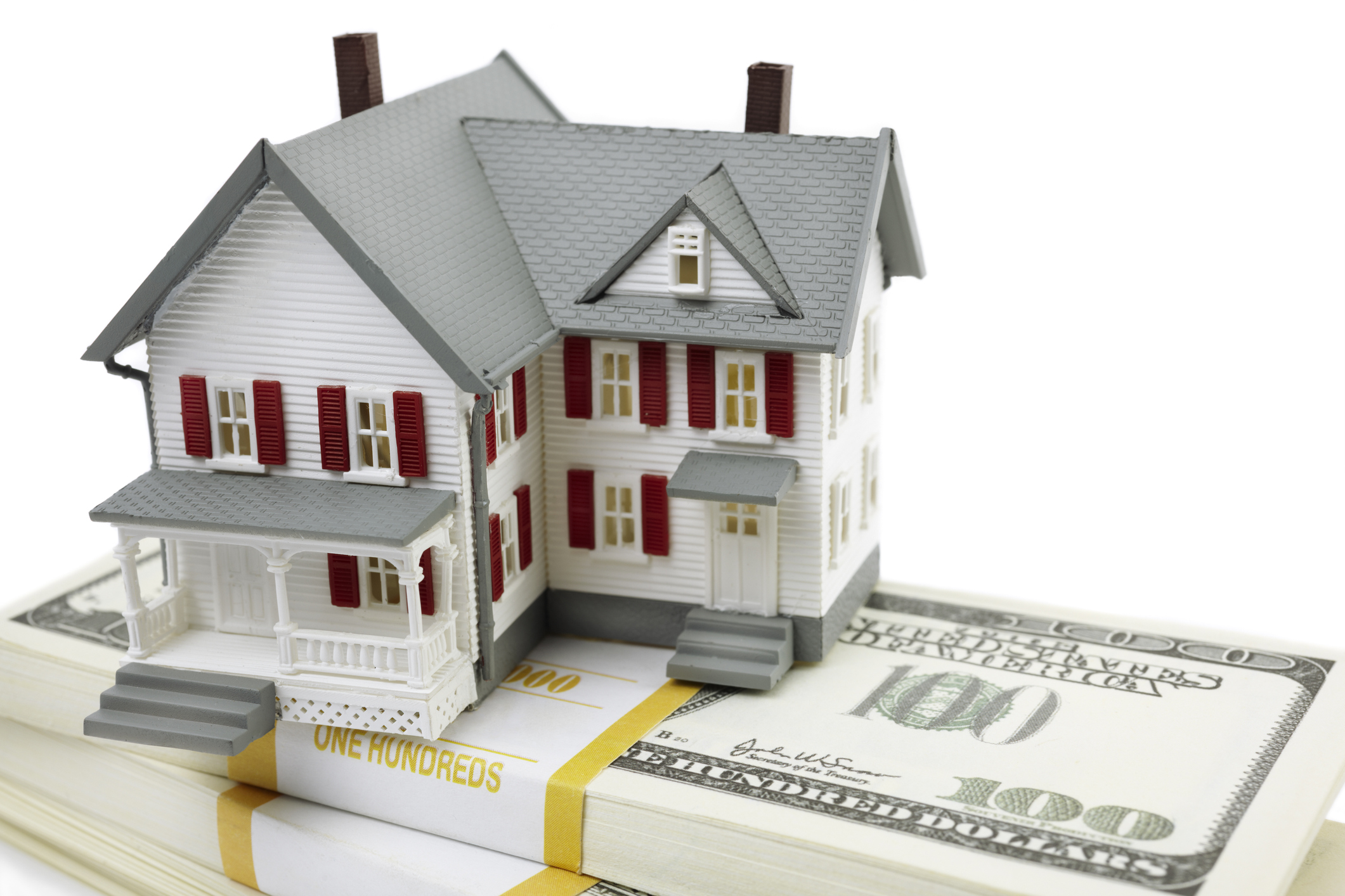 Model of house on $100 bills A model of a house sitting atop bundles of $100 bills.