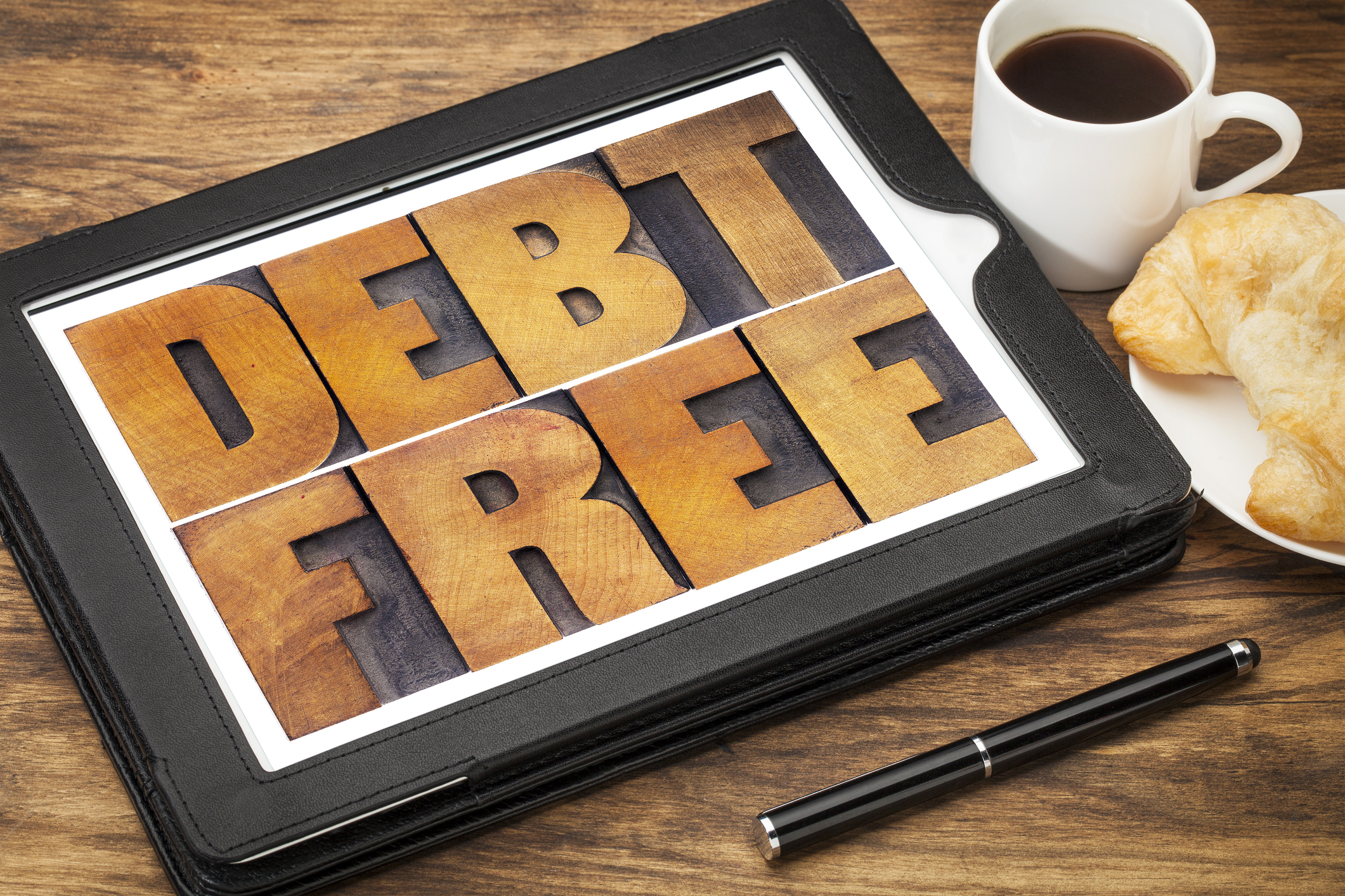 Debt free wooden sign on a tabletop.