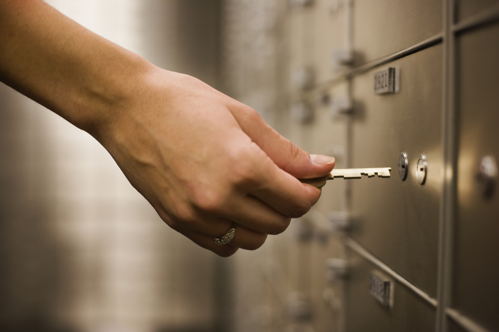 Person using key at safety deposit box. Person using key at safety deposit box.