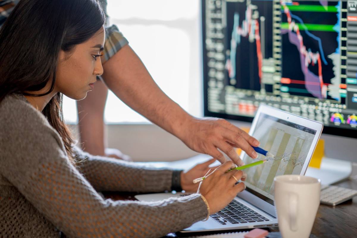 investing_image_for_call_vs_put_options_page_1200x800 Person learning about stocks and call versus put options while investing.