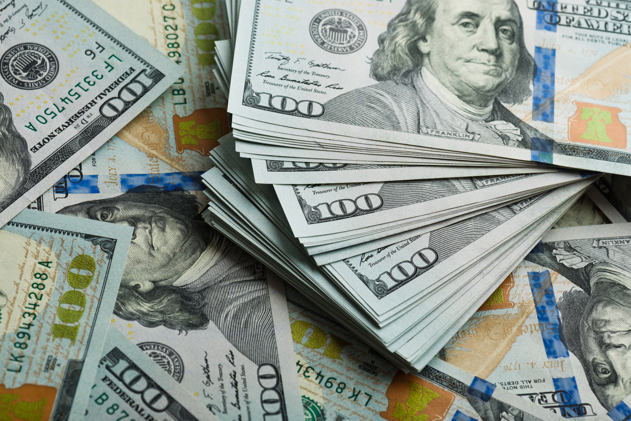 large pile of hundred dollar bills cash money savings rich
