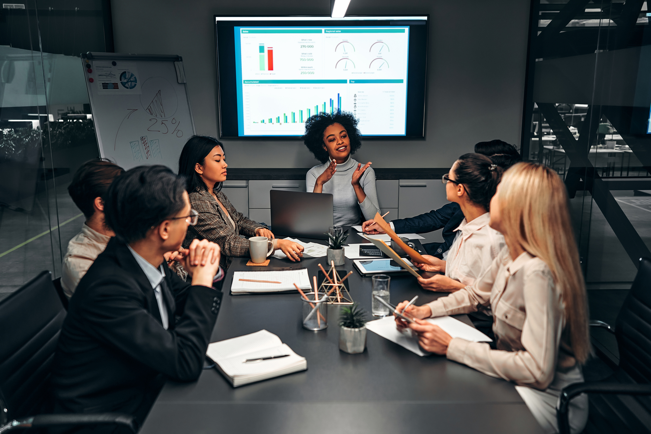 leadership - woman presenting slides Person presenting a slideshow in an office.