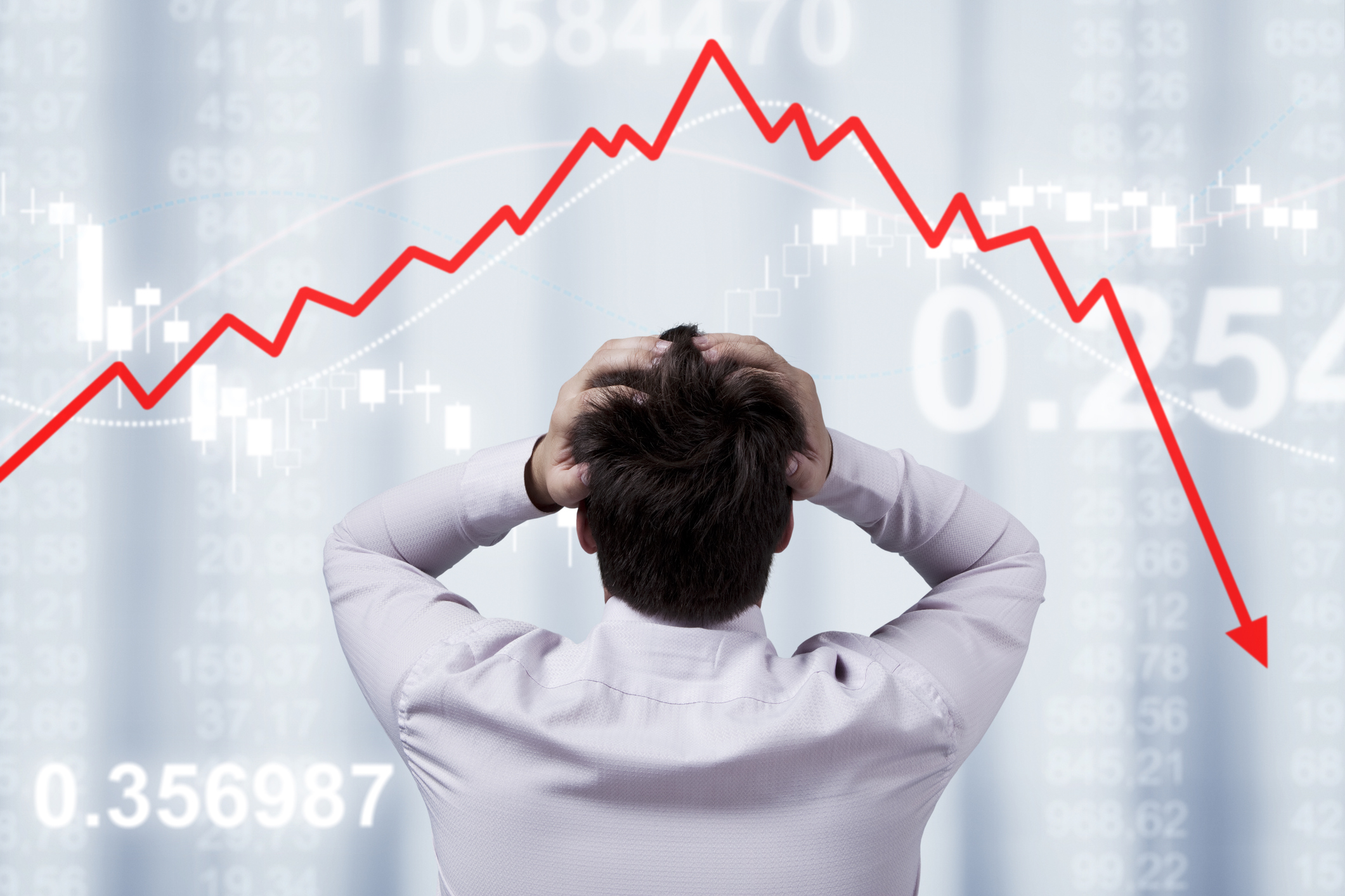 Person stressed looking at stock market crash