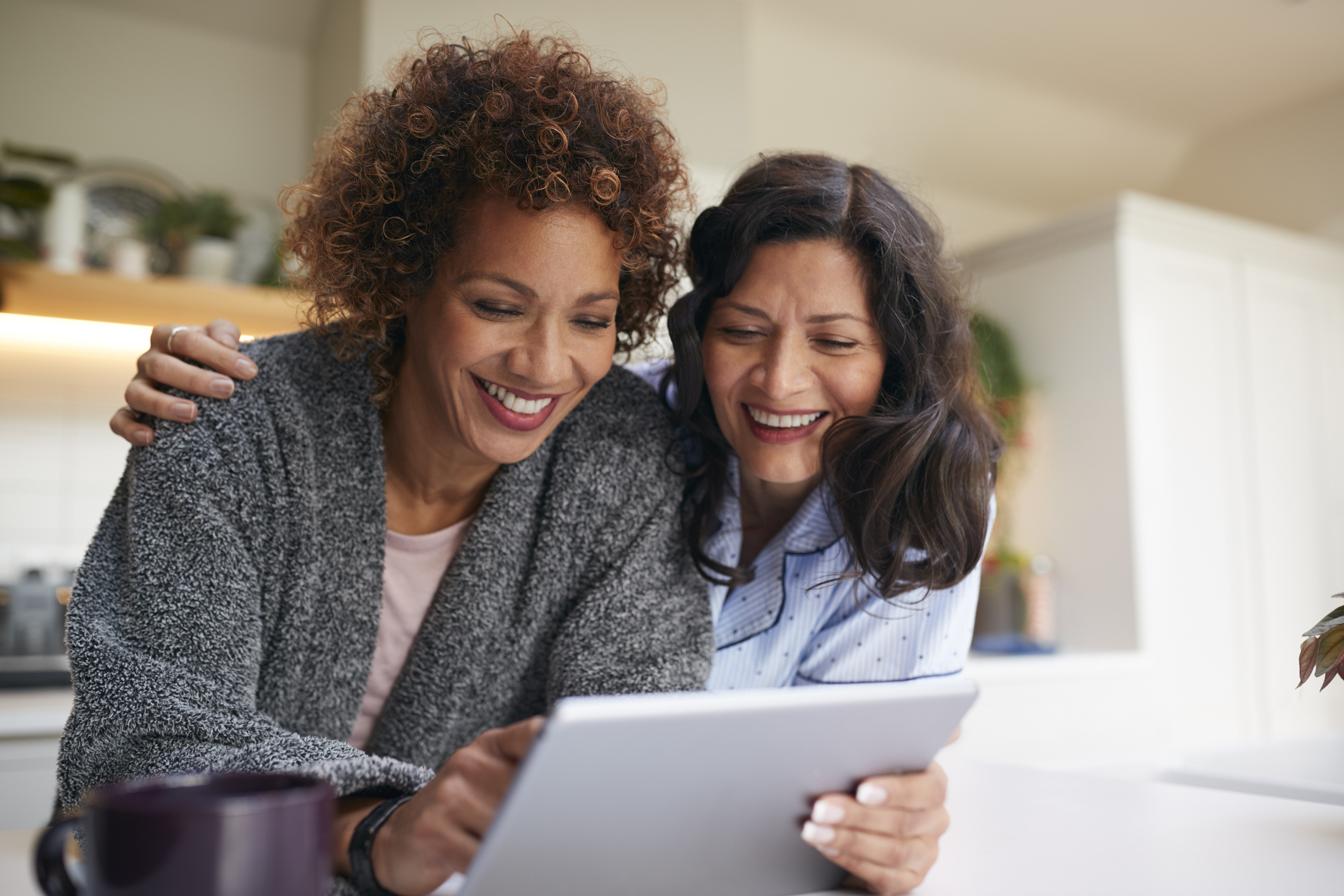 middle aged couple reviewing finances on tablet.jpg Two people reviewing finances on tablet.