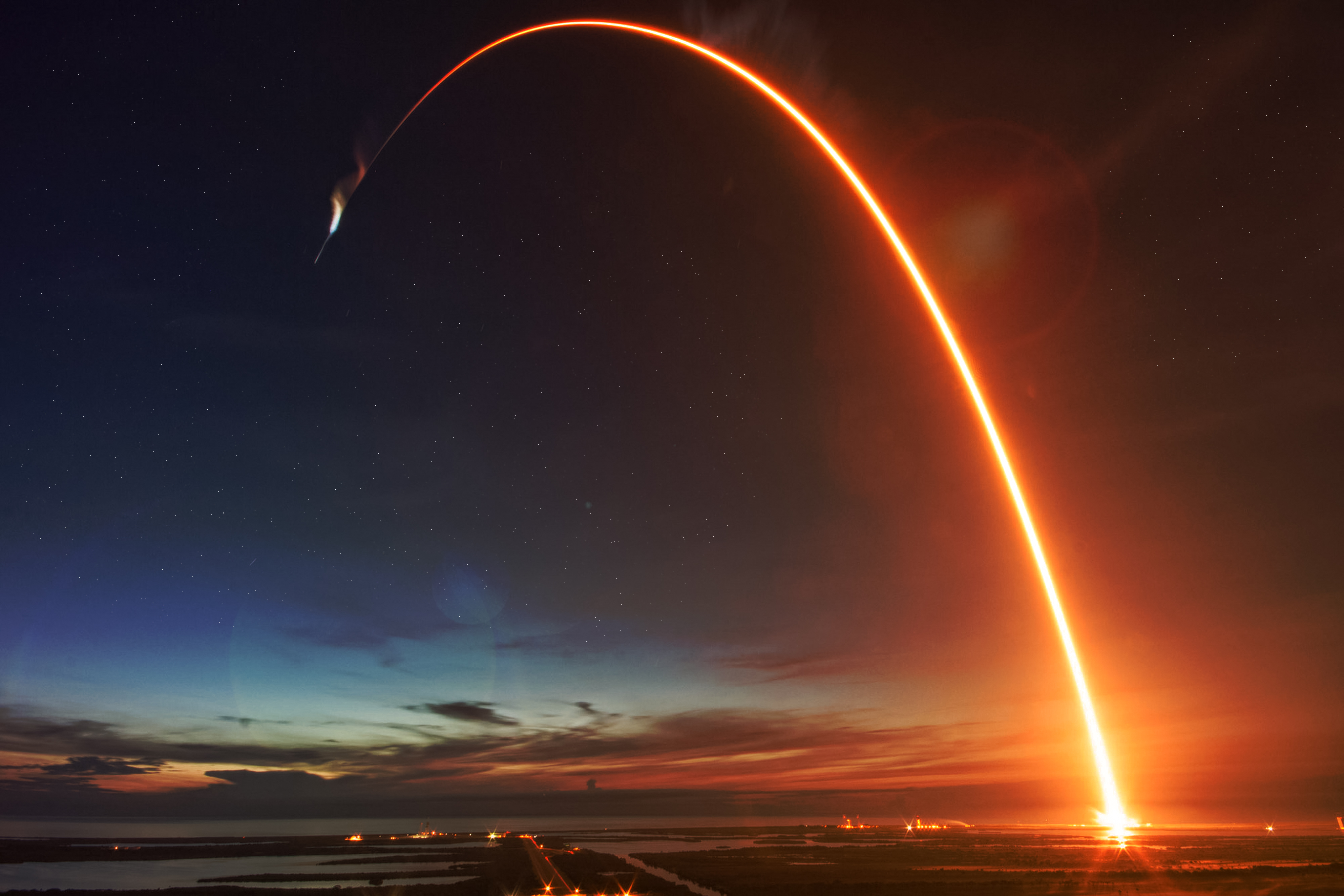 rocket path space travel Rocket launch with fire tracing its trajectory into space.