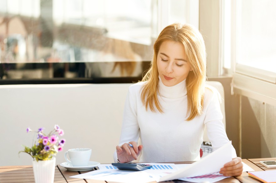 A person making a financial calculation. A person making a financial calculation.