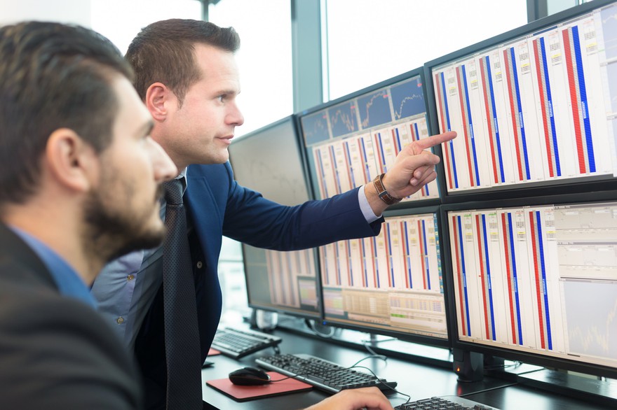 Stock traders looking at monitors. Stock traders looking at monitors.