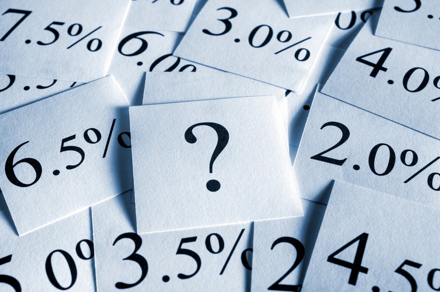sticky notes with different percentages and a single note with a question mark overlapping each other Slips of paper with various percentages written on them and a single slip with a question mark in the center.