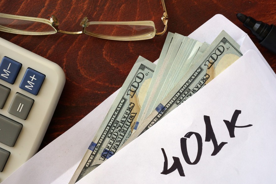 A cash stuffed envelope with "401K" written on it. A cash-stuffed envelope with 401K written on it.