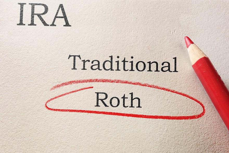 Paper with the words IRA, Traditional, and Roth written on it and the word Roth circled.