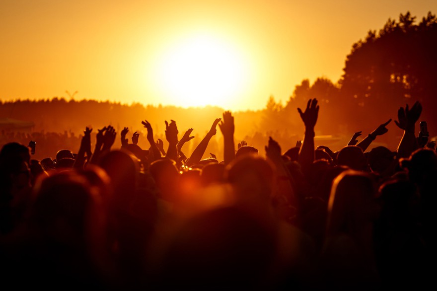 People with their hands in the air at an outdoor concert. People with their hands in the air at an outdoor concert.