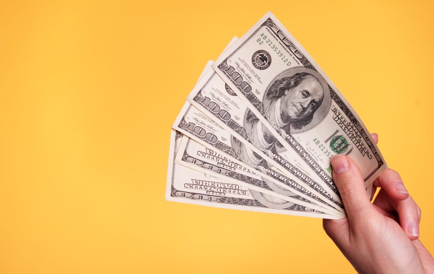Left hand fans five $100 bills. Left hand fans five $100 bills.