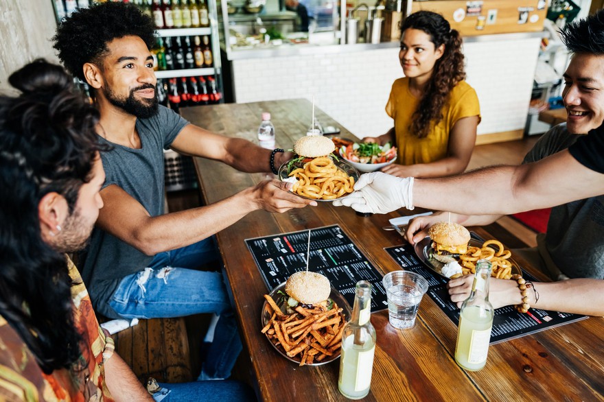 A group of people eating at a restaurant. A group of people eating at a restaurant.