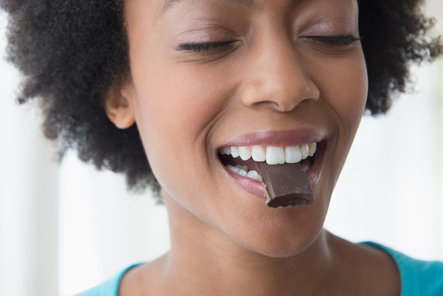 Someone eating a piece of chocolate. Someone eating a piece of chocolate.
