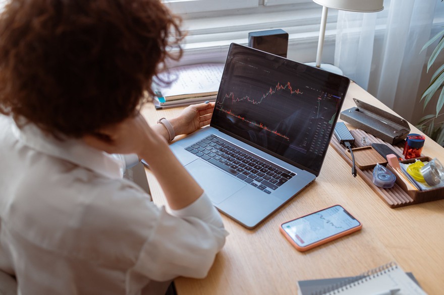 A person looking at a stock chart on a laptop. A person looking at a stock chart on a laptop.
