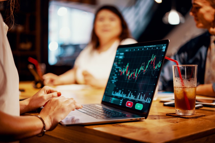 Women looking at stock charts on laptop. Women looking at stock charts on laptop.