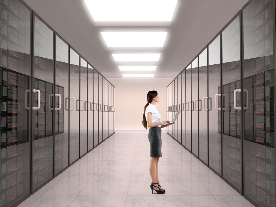 A person in a data center room. A person in a data center room.