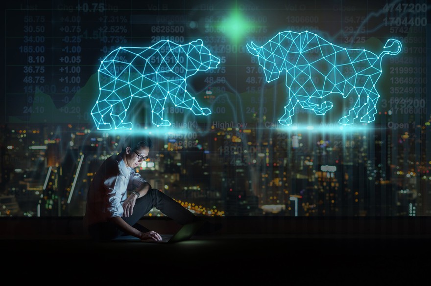 A man sitting on his phone with a bull and bear over him. A man sitting on his phone with a bull and bear over him.
