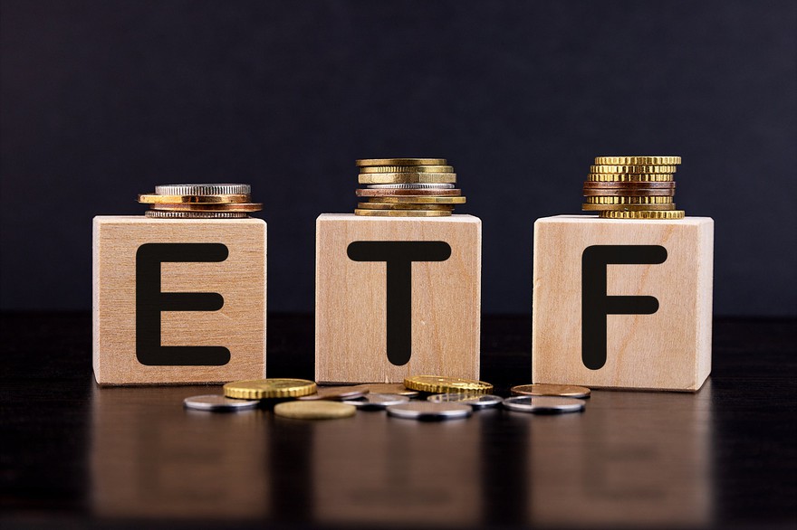 Blocks with the letters E, T, and F on them with gold and silver coins around them.