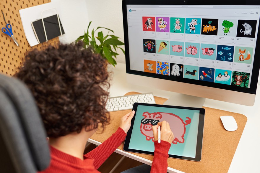 A young person drawing a digital image on a tablet. A young person drawing a digital image on a tablet.