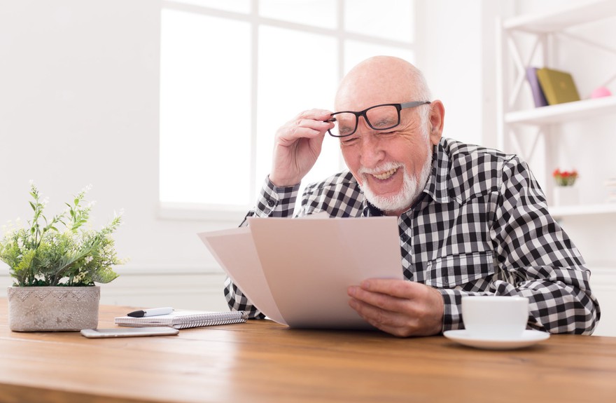 Man reading documents looking confused. Man reading documents looking confused.