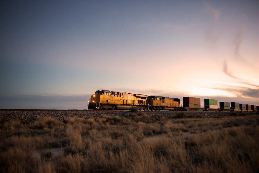 A train rolling through fields. A train rolling through fields.