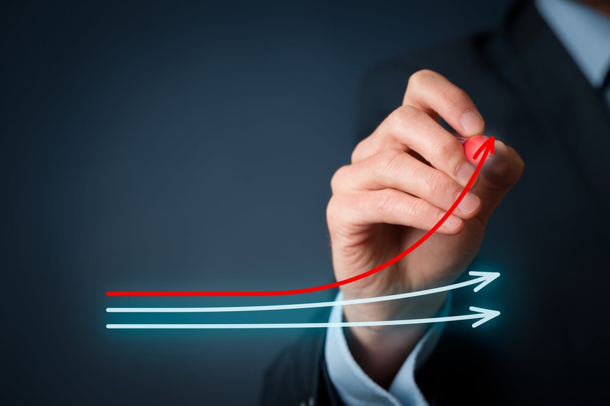 Businessperson draws three lines, two straight blue lines and one red line that is trending upward. Businessperson draws two straight blue lines and one red line that is trending upward.