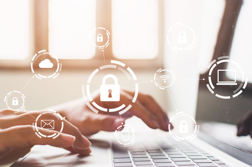 Someone using a computer, an illustrated lock is in the foreground. Someone using a computer, with an illustrated lock and other internet-related icons in the foreground.