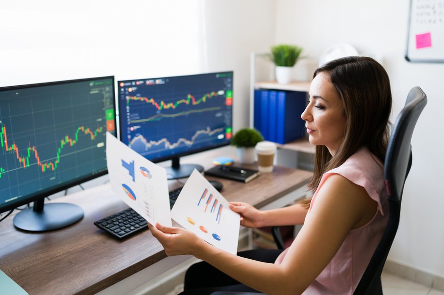 A broker working on stock research. A broker working on stock research.