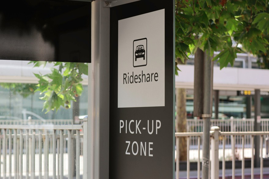 Sign indicating a rideshare pickup location. Sign indicating a rideshare pickup location.